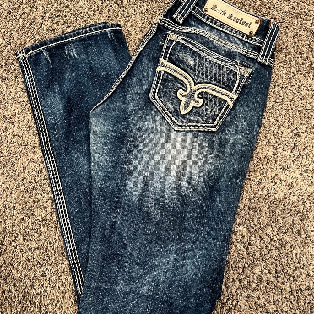 Rock Revival Blue Boot Cut Jeans with Distressed Look and Elaborate Stitching